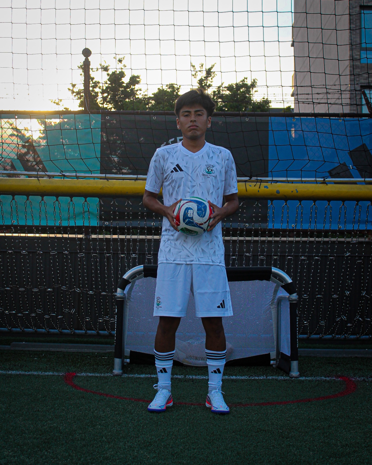 Player portrait in white kit at golden hour