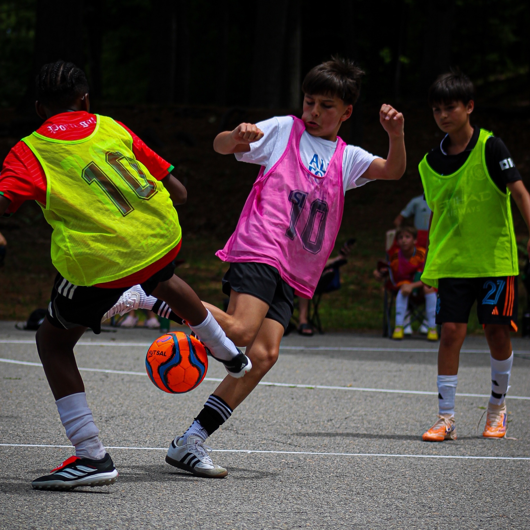 Youth players competing in a futsal match