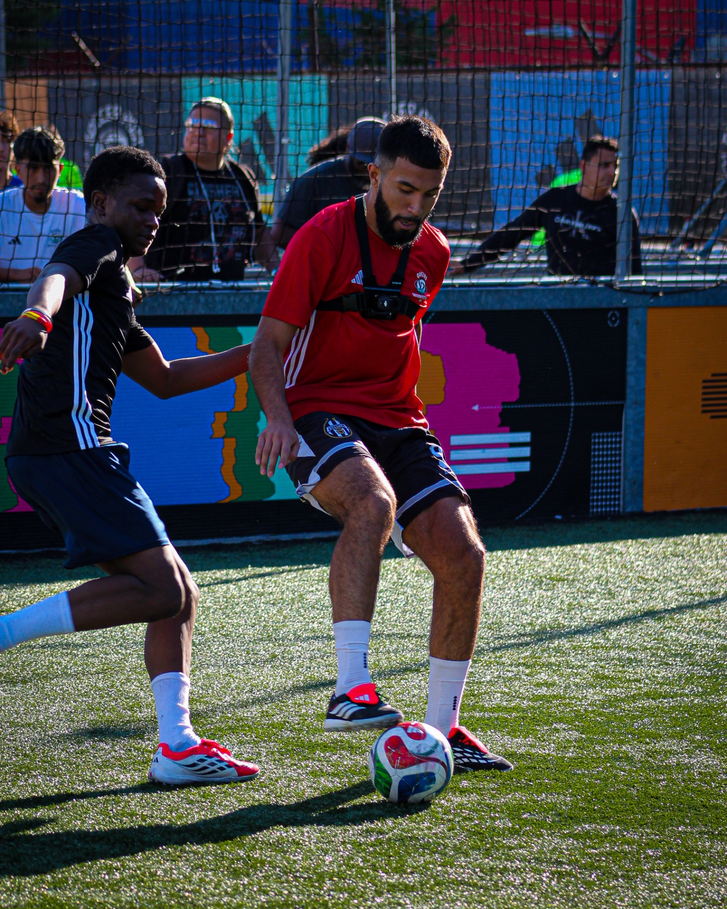 Player shielding the ball from a defender